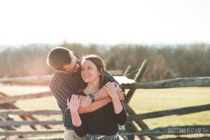 engaged couple embracing at gettysburg battlefield engagement