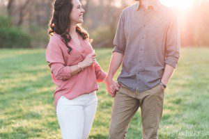 engaged couple holding hands at sunset ash mill farm