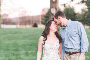 engaged couple nuzzling spring engagement ash mill farm