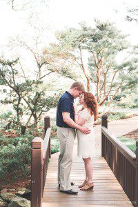 engaged couple on bridge at hershey gardens