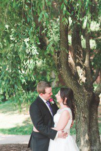 bride and groom embracing summer wedding