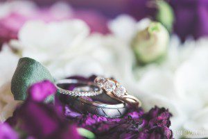 wedding rings on purple flower bouquet