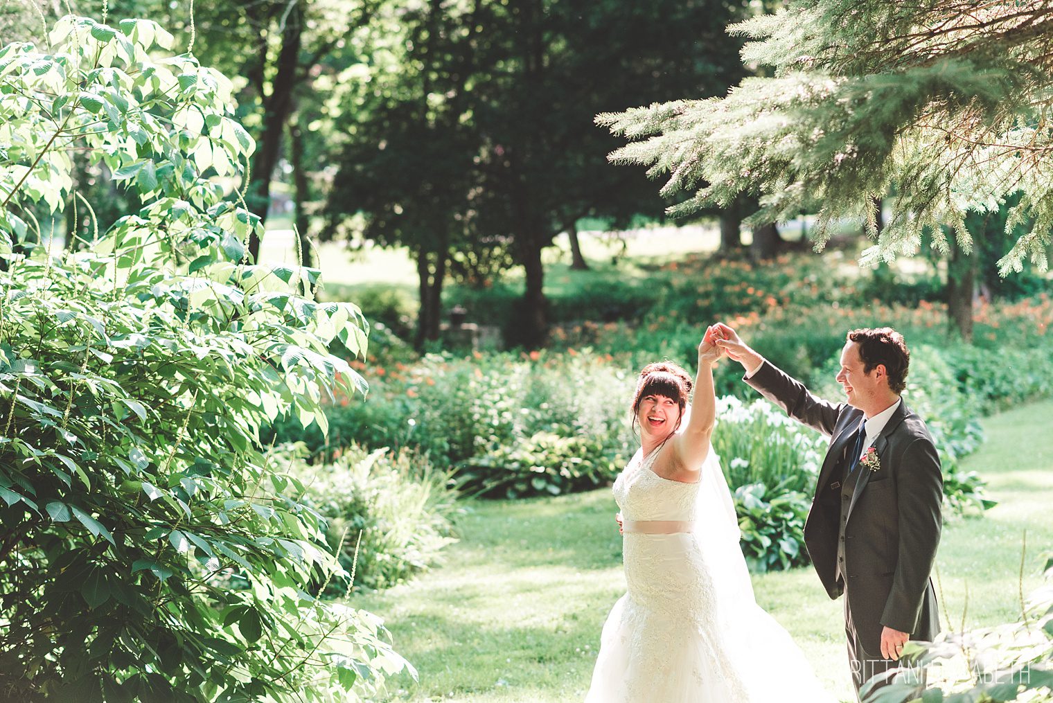 bride and groom spinning in garden historic shady lane