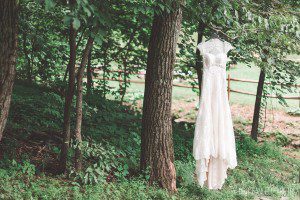 ivory lace country style wedding dress hanging from tree