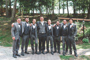 groom with groomsmen in gray suits summer wedding
