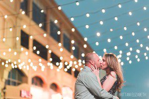 engaged couple kissing italian string lights atlantic city