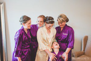 bride bridesmaids flower girl getting ready in robes