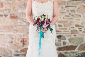 vintage bride holding plum teal bouquet