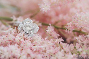 white gold floral engagement ring on pink flowers