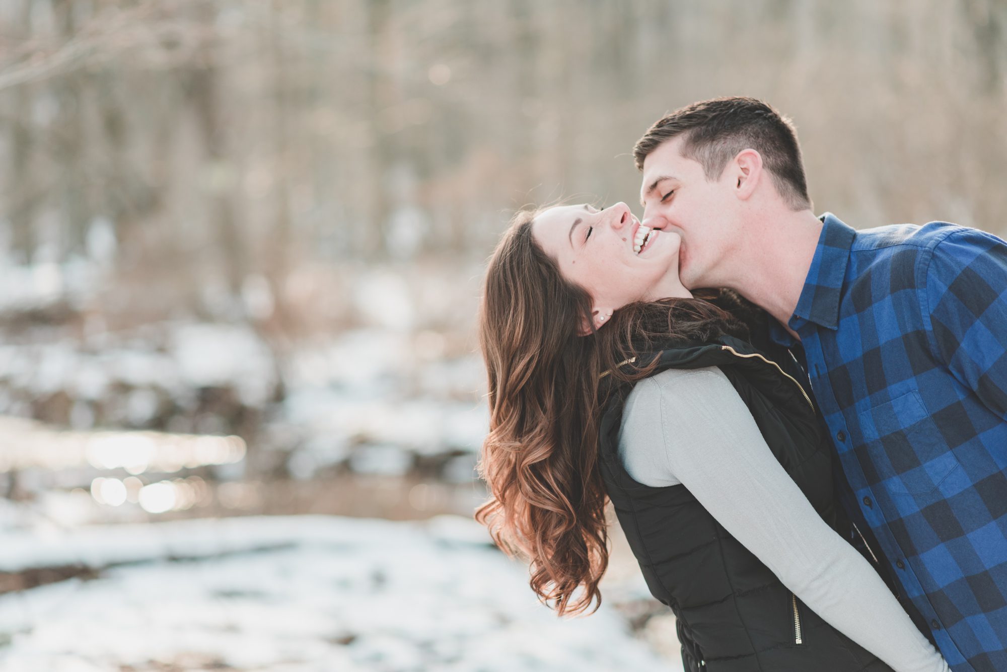 engaged couple kissing woods lancaster winter engagement