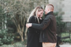 engaged couple laughing happy hugging west chester university campus proposal