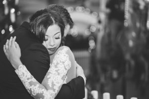 black and white bride and groom hugging