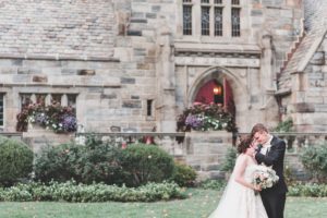 bride and groom in front of saint colman stone church