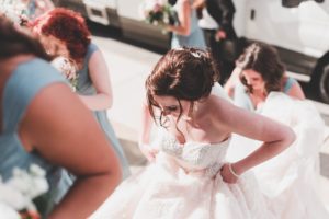 bride arriving at church with bridesmaids