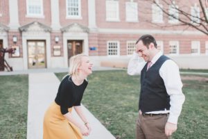 engaged couple laughing in front of brick building gettysburg college