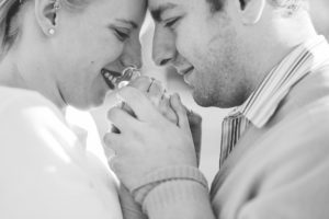 black and white engaged couple holding hands