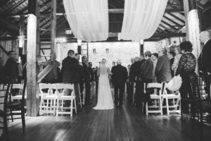 black and white father walking bride down the aisle barn wedding