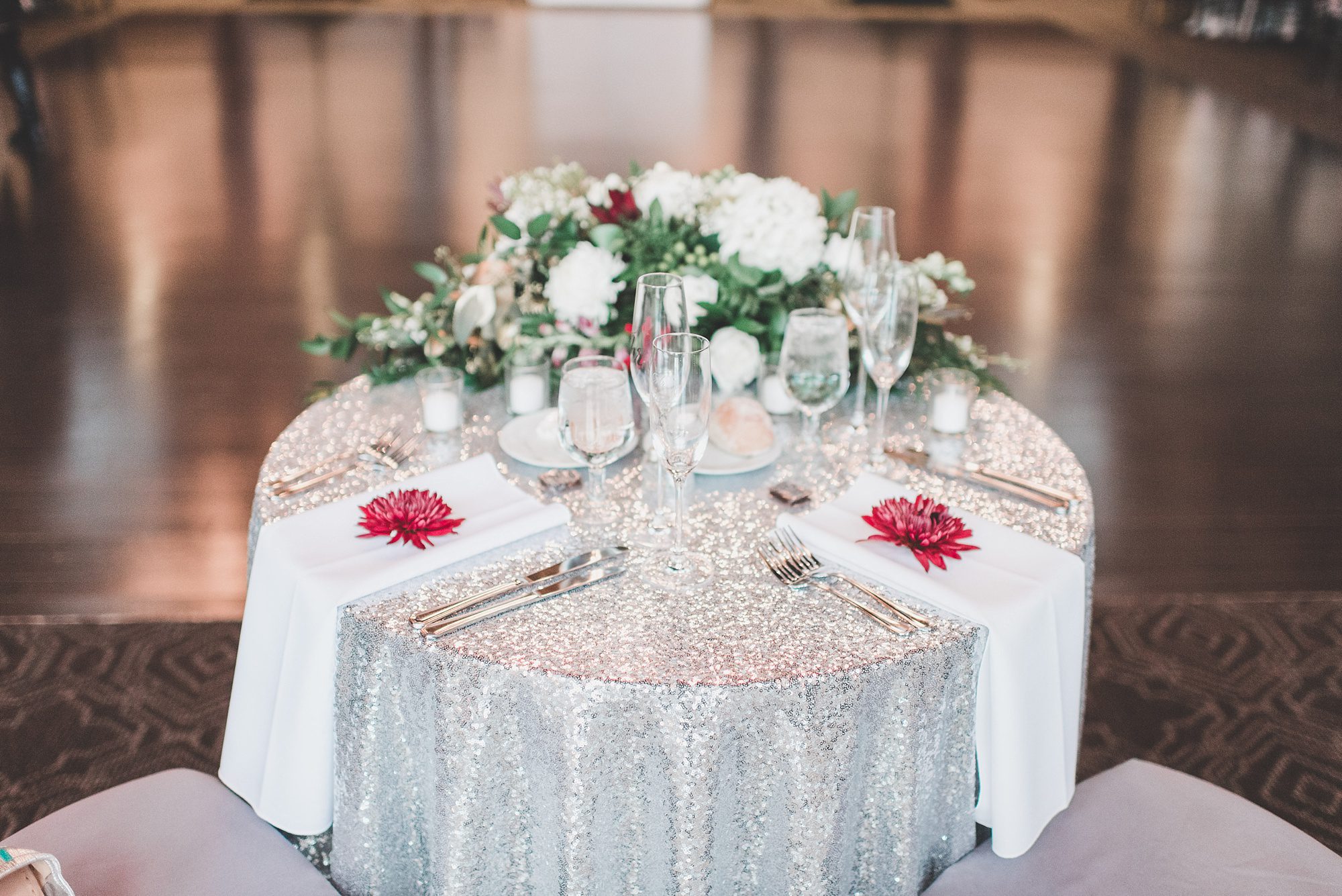 silver sequin sweetheart table floral centerpiece