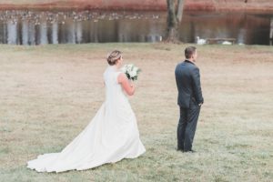 bride first look outside by pond winter wedding