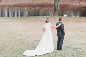 bride and groom first look by pond winter wedding