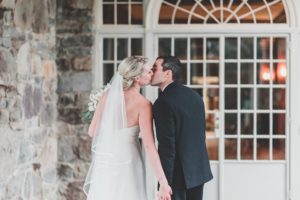 bride and groom kissing holding hands skytop lodge