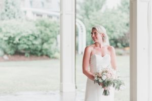 bride holding bouquet in sweetheart white wedding gown