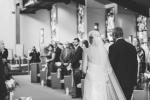 black and white father walking bride down aisle