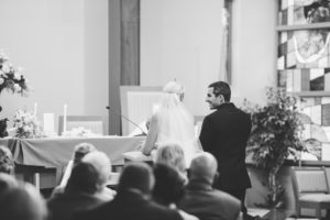 bride and groom kneeling at altar catholic wedding