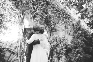 bride and groom black and white first look hugging