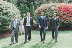 groom and groomsmen walking gray and blue suits