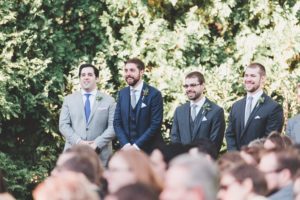groom and groomsmen outside at wedding ceremony