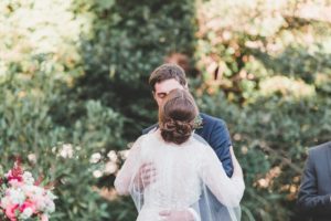bride and groom first kiss fall outdoor wedding ceremony