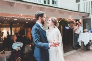 bride and groom first dance outside courtyard