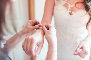 bride getting ready putting on bracelet