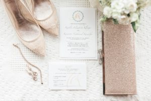 gold and white wedding details wedding invitation flat lay