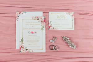 flat lay wedding invitation rings jewelry details
