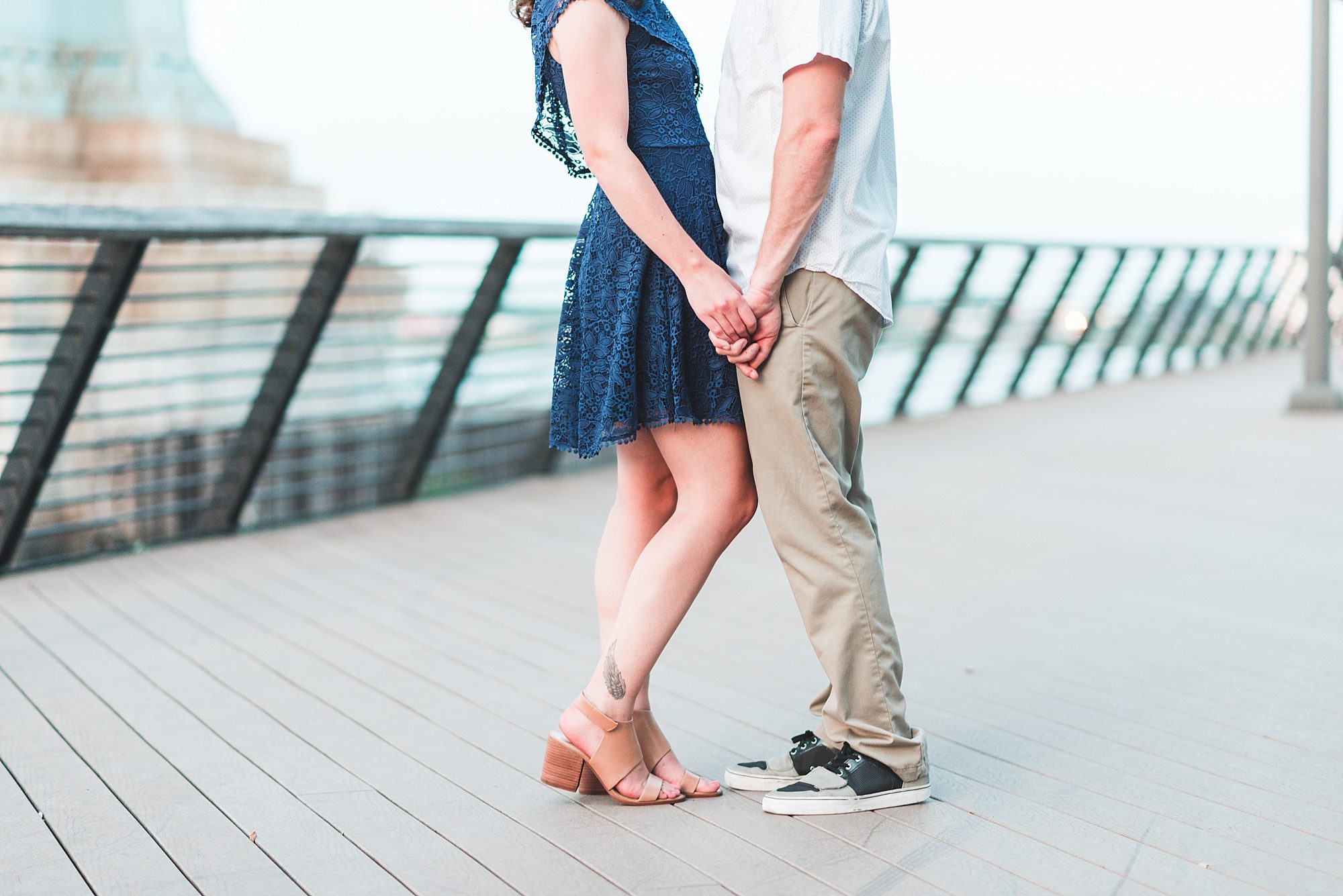 engaged couple holding hands by delaware river philadelphia engagement