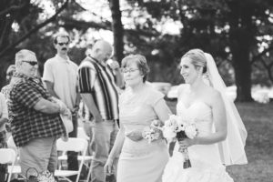 mother walking bride down the aisle