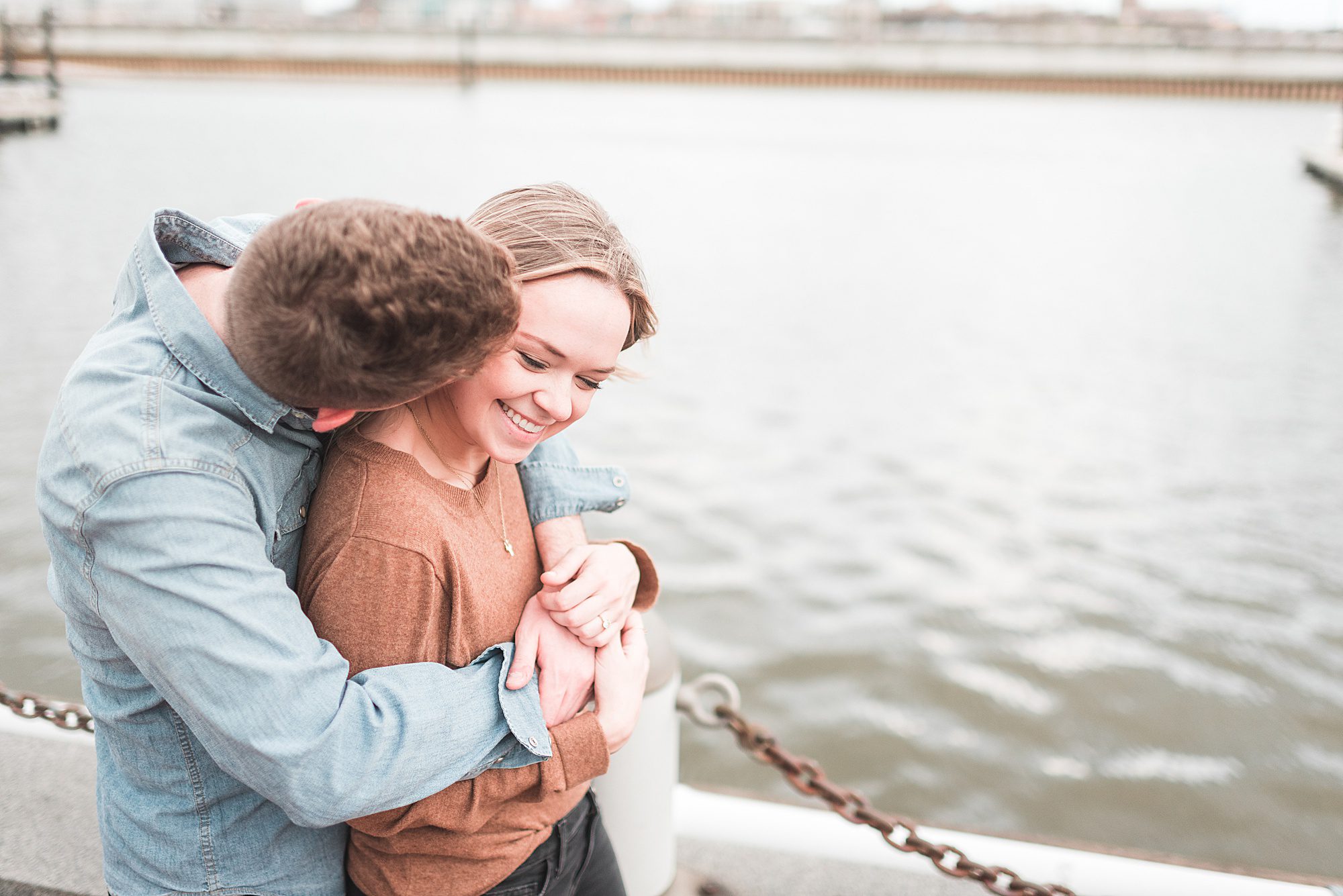 Couple hugs by the water at Spruce Street Harbor Park