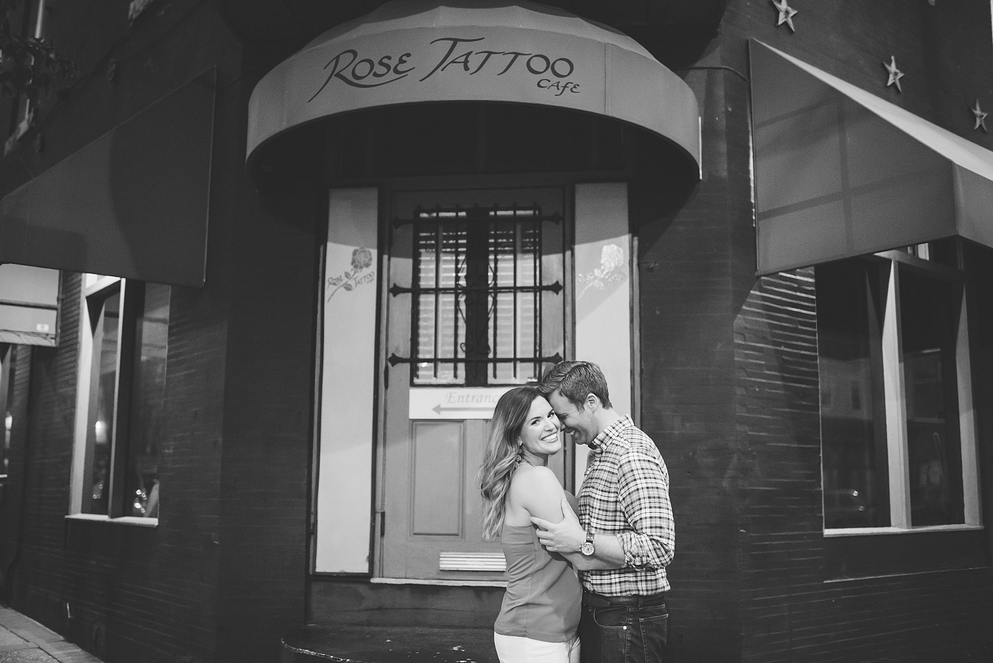 Couple kisses outside of Rose Tattoo Cafe in Fairmount