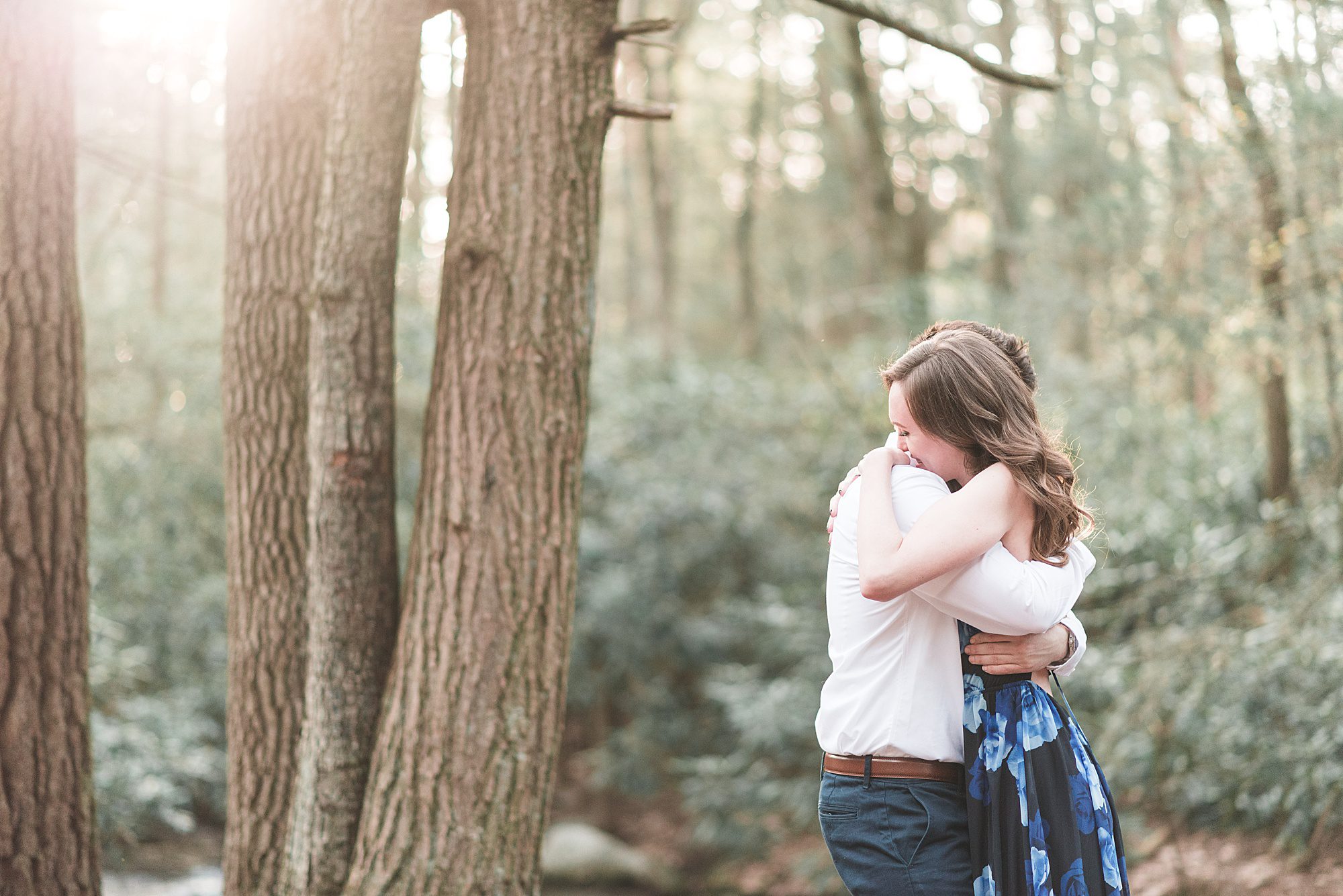 Engaged Couple Hugs in woods at Jim Thorpe Camping Resort